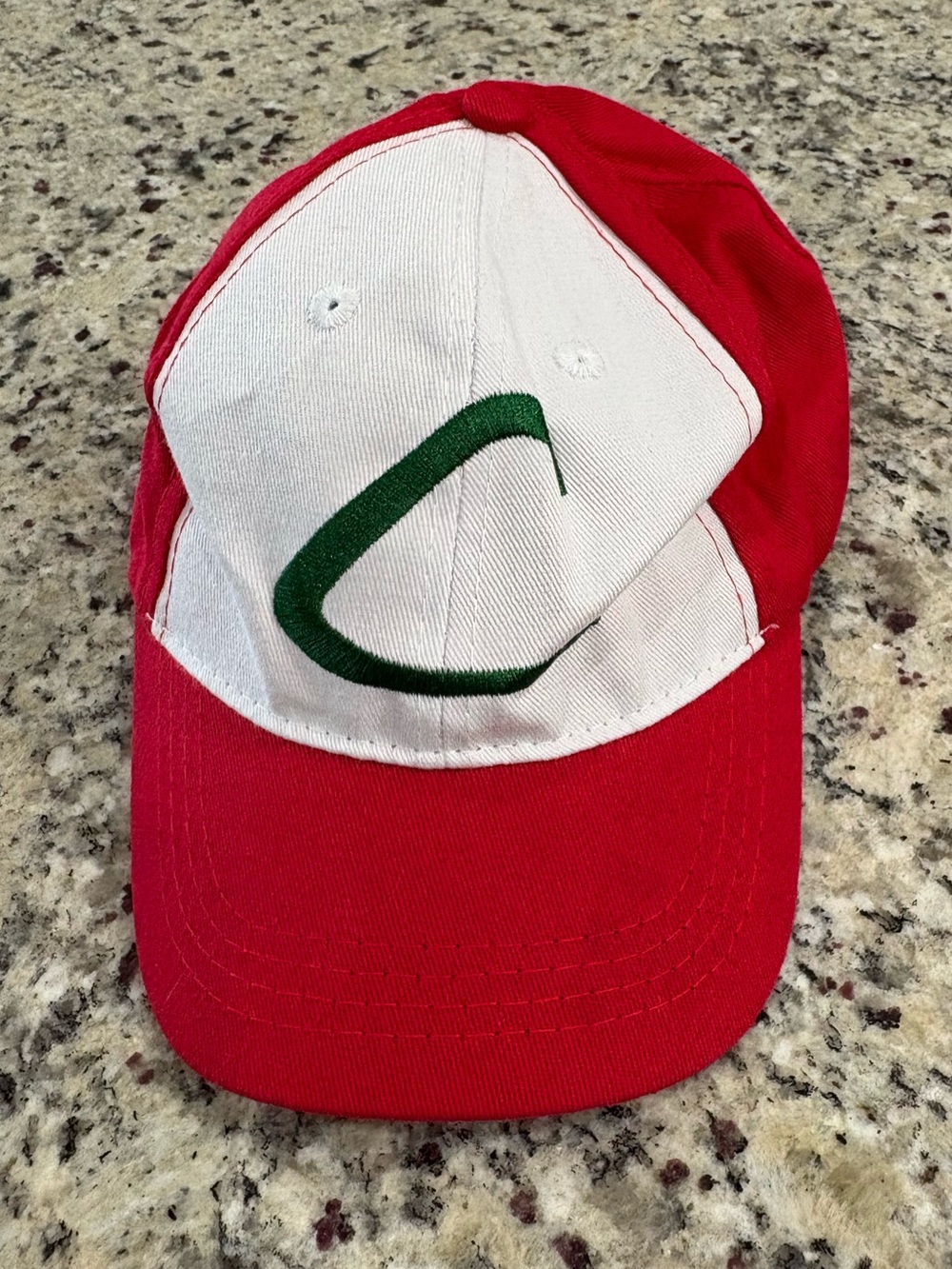 Red and white baseball cap with green embroidered “C” child size GUC
